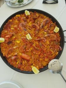 a pan of food with shrimp and other ingrediants at Hostal Restaurante Playa in Colònia de Sant Jordi +17 photos