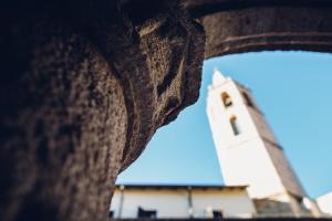 a building with a clock tower in the background at San Francesco Heritage Hotel in Alghero