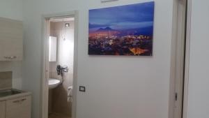 a view of a bathroom with a picture on the door at Flaviogioia Apartment in Naples