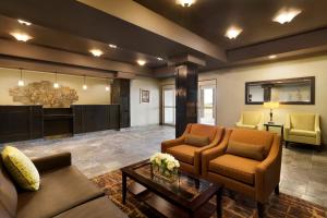 a living room with two couches and a table at Days Inn by Wyndham Innisfail in Innisfail
