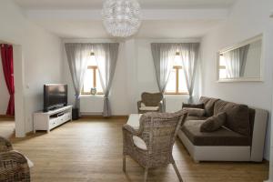 a living room with a couch and a tv at Ferienwohnungen EULE in Lutherstadt Wittenberg