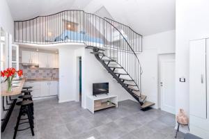 a kitchen and dining room with a staircase in a house at Villa Riva in Jelsa