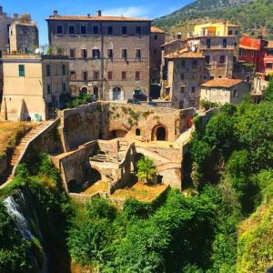 um grupo de edifícios no topo de uma colina em La Mensa Ponderaria em Tivoli