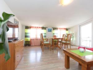 a kitchen and dining room with a table and chairs at Apartments & Rooms Nikolić in Fažana