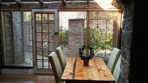 a wooden table with chairs and a potted plant on it at Historic Hideaway in Cork City Centre in Cork