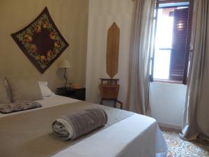 a bedroom with a bed with a towel on it at Casa Elvira in Baratili San Pietro