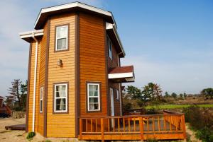 a small wooden house with a large deck at Sweetsalt in Seogwipo