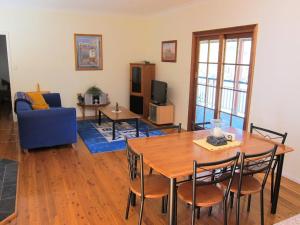 a living room with a table and a blue couch at Neds Cabin in Amiens