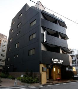 a large building with a sign on the side of it at Sumiya Spa & Hotel in Hiroshima