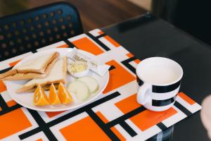 a plate of food and a cup of coffee on a table at So Art Guesthouse in Sanyi