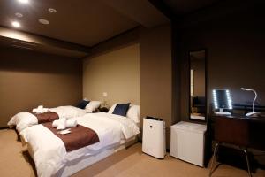Postel nebo postele na pokoji v ubytování Sumiya Spa & Hotel