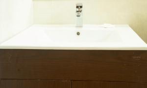 a bathroom sink with a faucet on top of it at Vibhav Grand in Haridwār