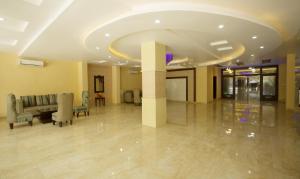 a lobby with chairs and a table in a building at Vibhav Grand in Haridwār