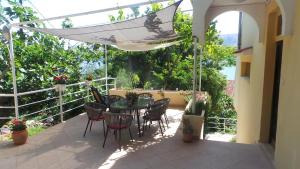 a patio with a table and chairs and an umbrella at Apartments Andrea in Baška