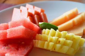 a plate of fruit on a plate at Cocotinos Sekotong Lombok in Sekotong