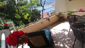 a balcony with a television and a view of the ocean at Apartments Andrea in Baška