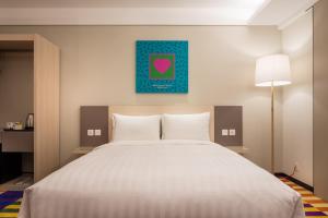 Postel nebo postele na pokoji v ubytování Green World Hotel - Zhonghua