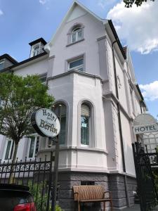 a white house with a sign in front of it at Hotel Haus Berlin in Bonn