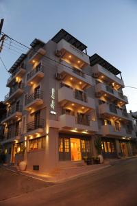 a large white building with lights on it at Sunbeam in Agios Nikolaos