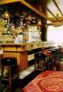 a bar with bar stools in a room at Hotel Lahaye in Valkenburg