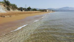 a beach with the ocean and the shoreline at Kefalonia Beach Hotel & Bungalows in Lixouri