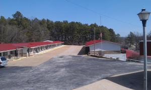 a large parking lot with a building with red roofs at Family Budget Inn Harrison in Harrison