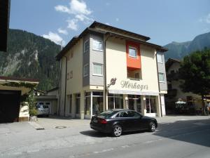 a black car parked in front of a building at Apartment Hörhager in Mayrhofen
