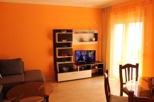 a living room with a tv and a table at Apartment Ruby in Mandre