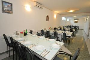 a group of tables and chairs in a room at Pansion Bojic in Međugorje