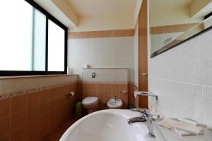 a bathroom with a sink and a toilet at Poseidon in Ispica