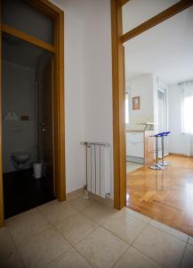 an open door to a room with a toilet and a kitchen at Apartment Luka in Zagreb +26 photos