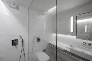 a white bathroom with a toilet and a sink at Evridiki in Kilkís +82 photos