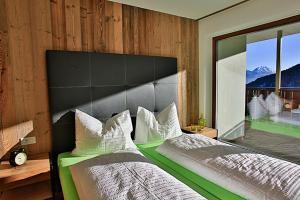 A bed or beds in a room at Familyparadies GAMPLALM