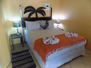 a bedroom with a bed with two towels on it at Jump Street Chalets in Maun