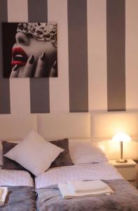 a bedroom with a picture of a woman with red lipstick at Morski Relax in Gdynia