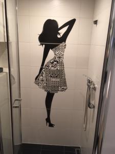 a silhouette of a woman on the wall of a shower at Morski Relax in Gdynia