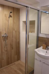 a bathroom with a shower and a sink at Morski Relax in Gdynia