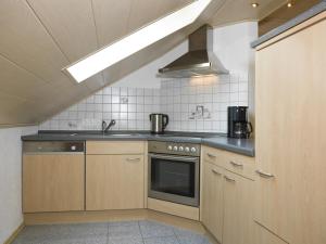 a kitchen with a sink and a stove top oven at Fewo Gabi in Neuschönau +12 photos