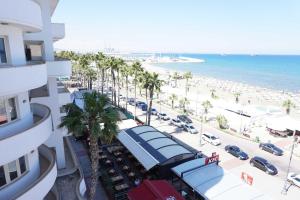 a view of a beach from a building with palm trees at Lazuli Sea View Beachfront Ap 43 in Larnaka