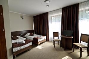 Posteľ alebo postele v izbe v ubytovaní Hotel Dąbrowski