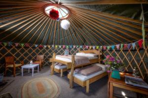 a room with two beds in a yurt at Swinton Bivouac in Masham