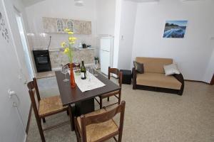 a dining room with a table and a living room at Marašić in Ždrelac +16 photos