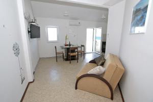 a living room with a couch and a dining room at Marašić in Ždrelac