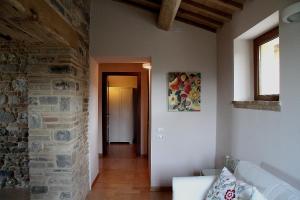 a living room with a couch and a stone wall at Al Castello in San Severino Marche