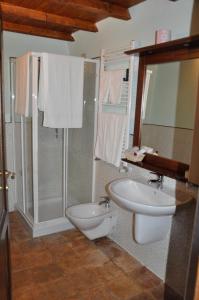a bathroom with a toilet and a sink at Residence Il Palazzo in Santo Stefano di Sessanio +64 photos