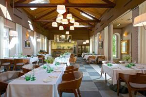 un ristorante con tavoli e sedie con tovaglie bianche di Zámek Ratměřice - Hotel & Resort a Ratměřice