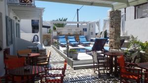 a patio with chairs and tables and a pool at La Luna in Ios Chora