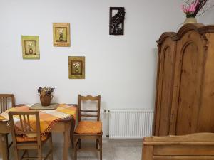 a dining room with a table and chairs and a cabinet at Apartmany u Dvora in Jihlava