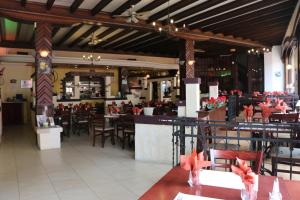 a restaurant with tables and chairs and a bar at Il Siciliano - Duc de Bouillon in Bouillon