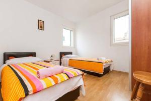 Posteľ alebo postele v izbe v ubytovaní Apartmani Dotur